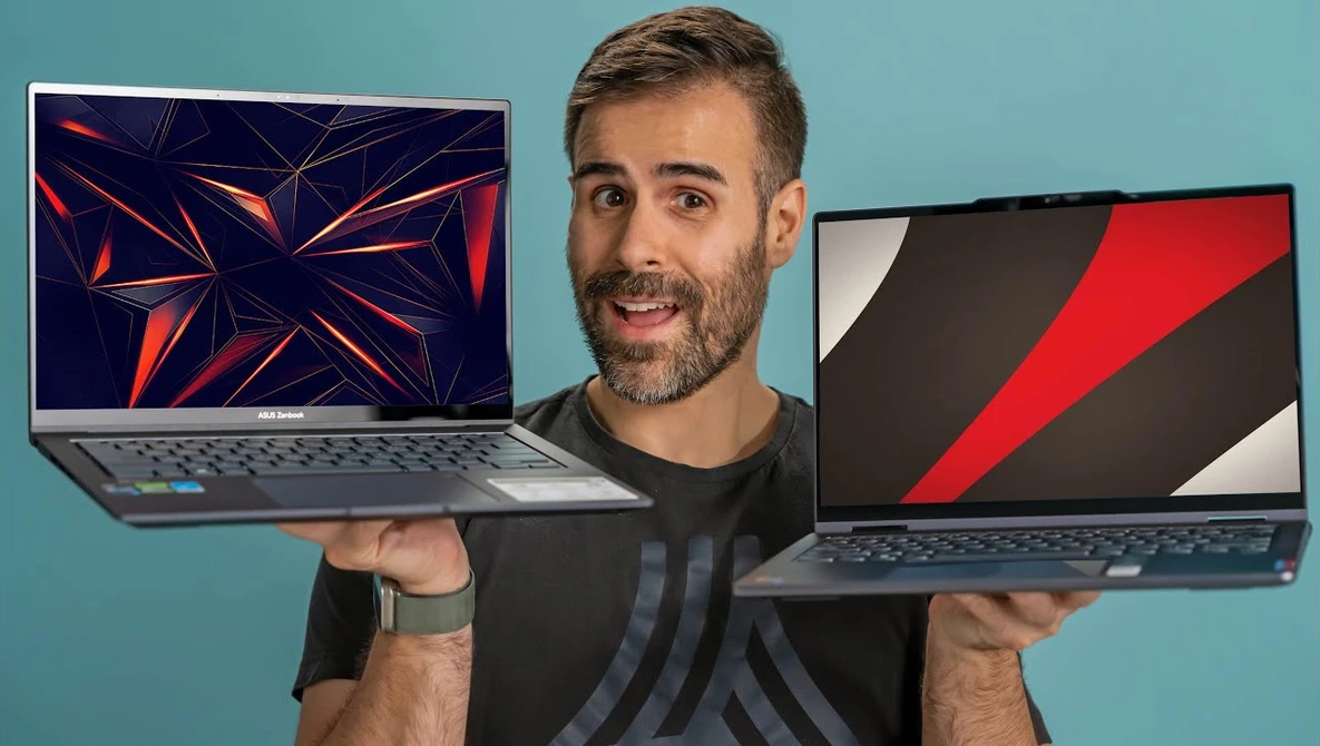 Man holding two open laptops displaying different geometric abstract wallpapers against a blue background.