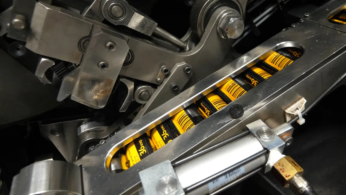 Close-up of a yellow and black coilover suspension system installed on a vehicle.