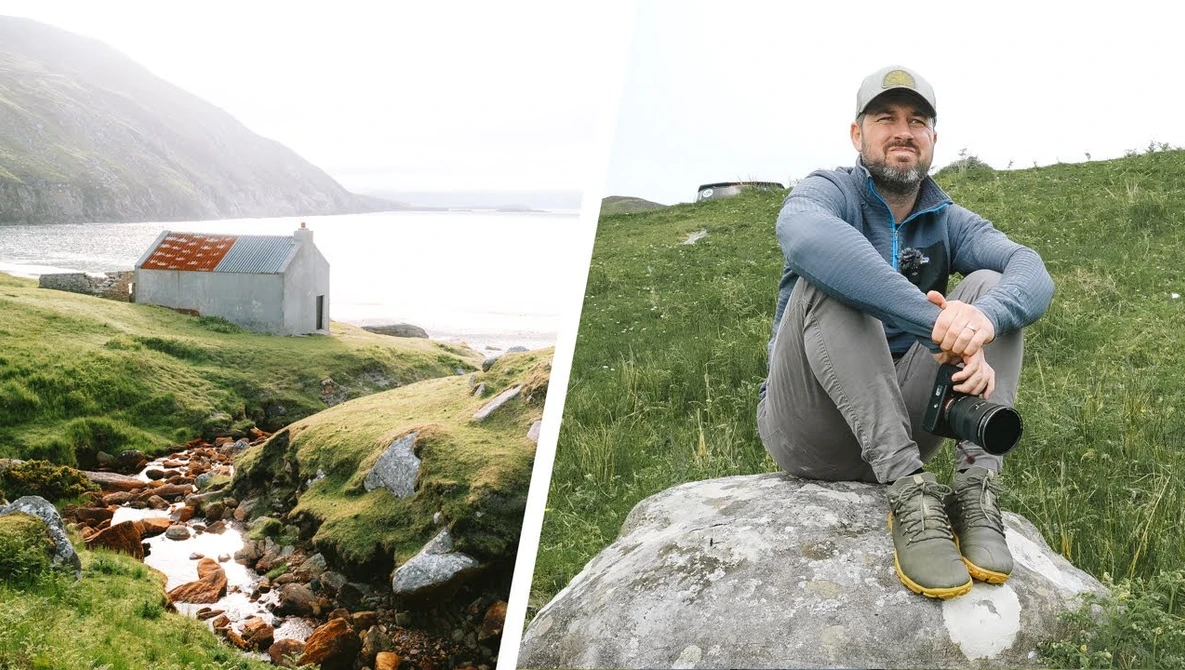 Photographer in hiking gear crouching on a boulder in a misty mountain valley with a stream below.
