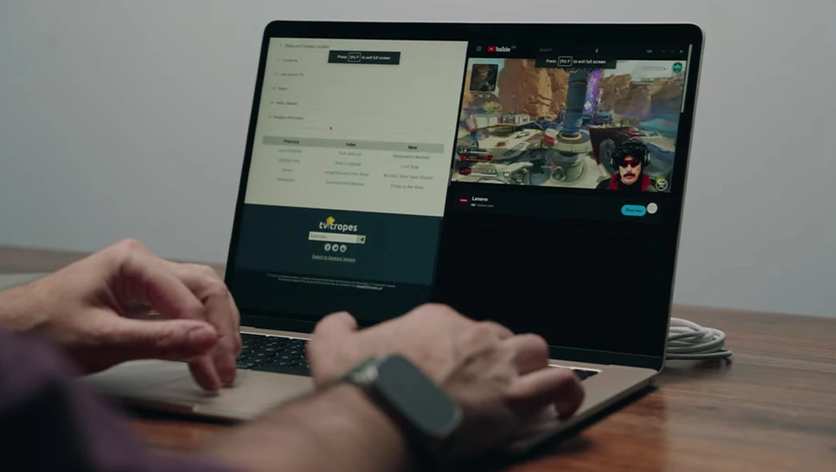 Hands using a laptop displaying split screens with a streaming interface and game footage.