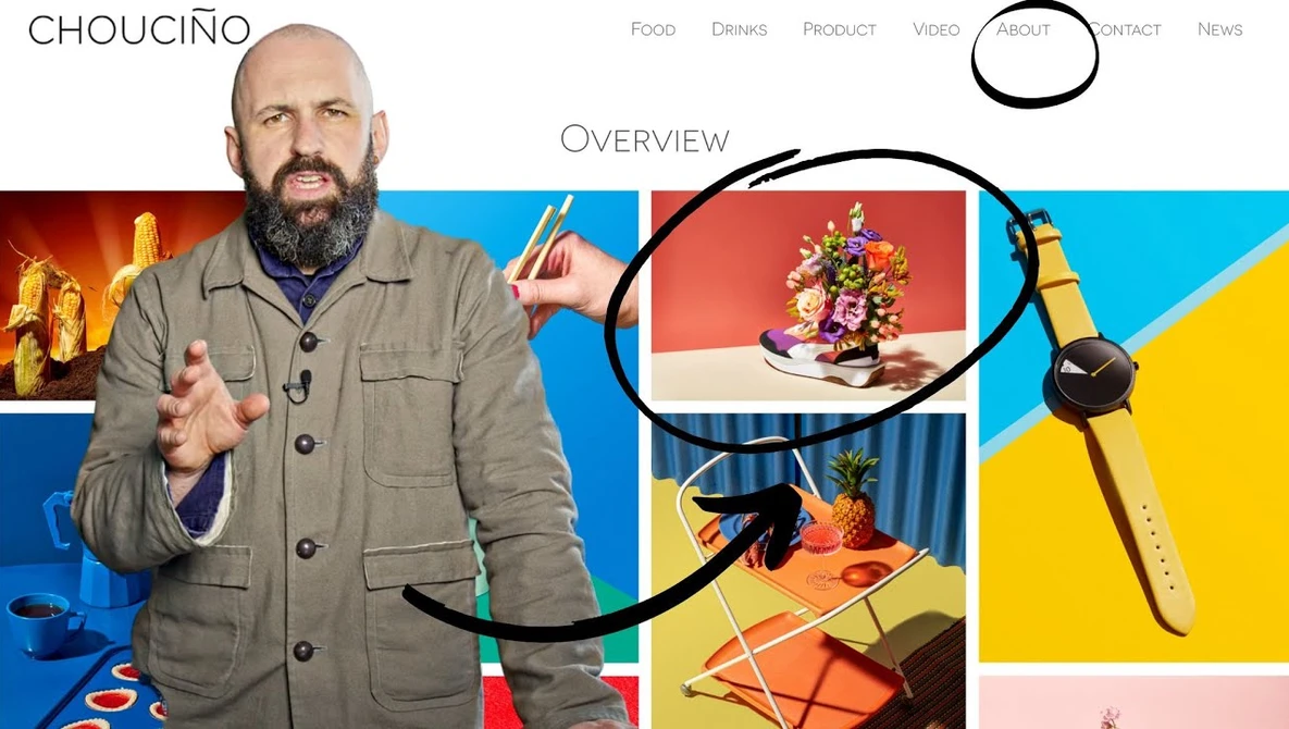 Man in tan jacket gestures while speaking, with colorful product photography examples displayed behind him.