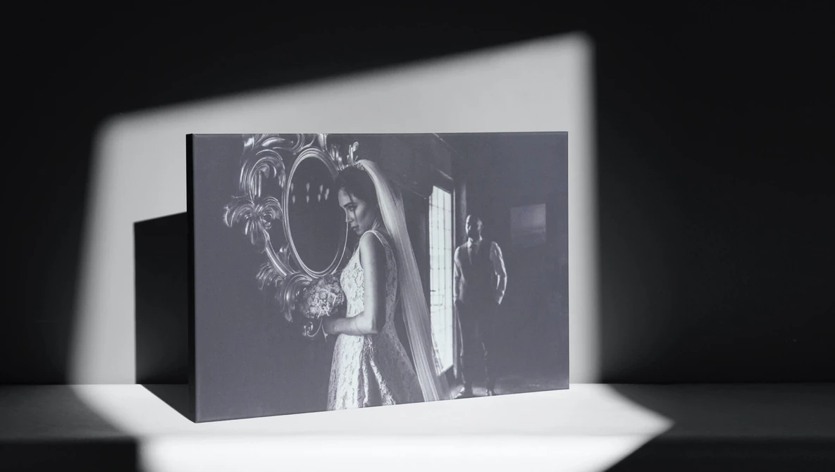 Black and white photograph displayed as a 3D printed or sculptural object with dramatic directional lighting casting shadows.