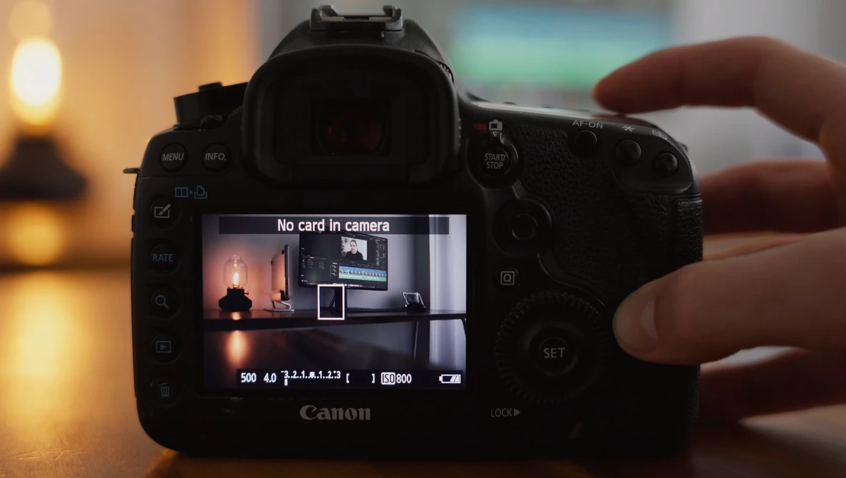 Canon DSLR camera displaying "No card in camera" error message on rear LCD screen.