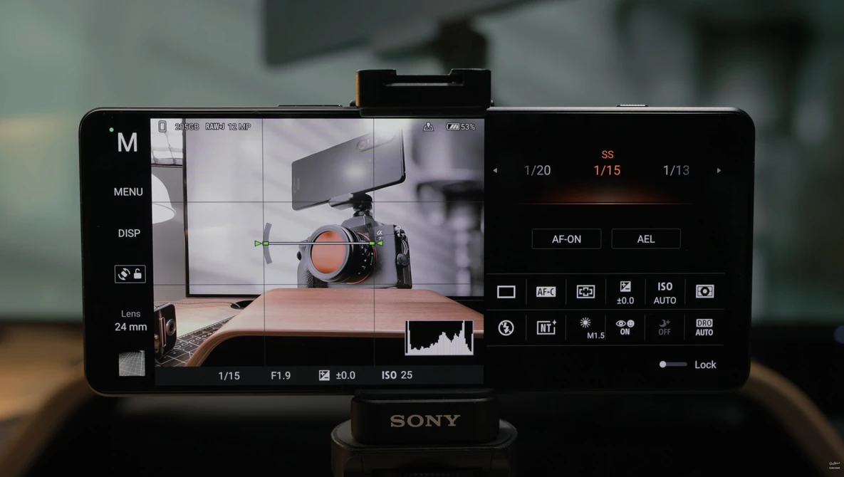 Sony mirrorless camera display showing live view of a professional camera on a wooden table with studio lighting setup.