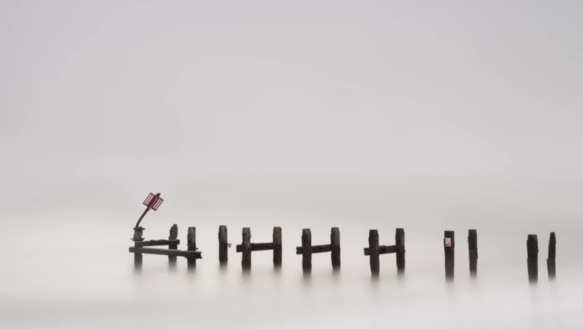 Tally marks etched into snow with a small figurine standing at the leftmost mark.