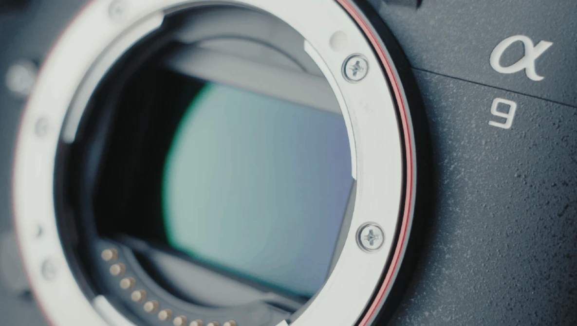 Close-up of a mirrorless camera body showing the open lens mount with visible sensor and electronic contacts.