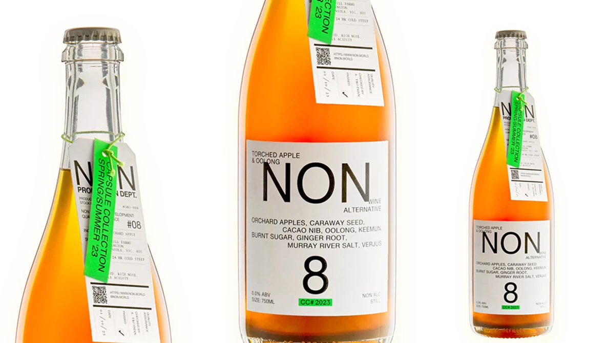 Three product photography angles of an orange NON 8 beverage bottle showing front label and side views.