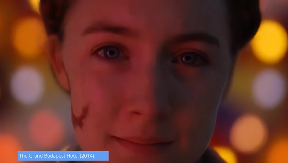 Close-up portrait with warm amber and orange bokeh lighting in the background.