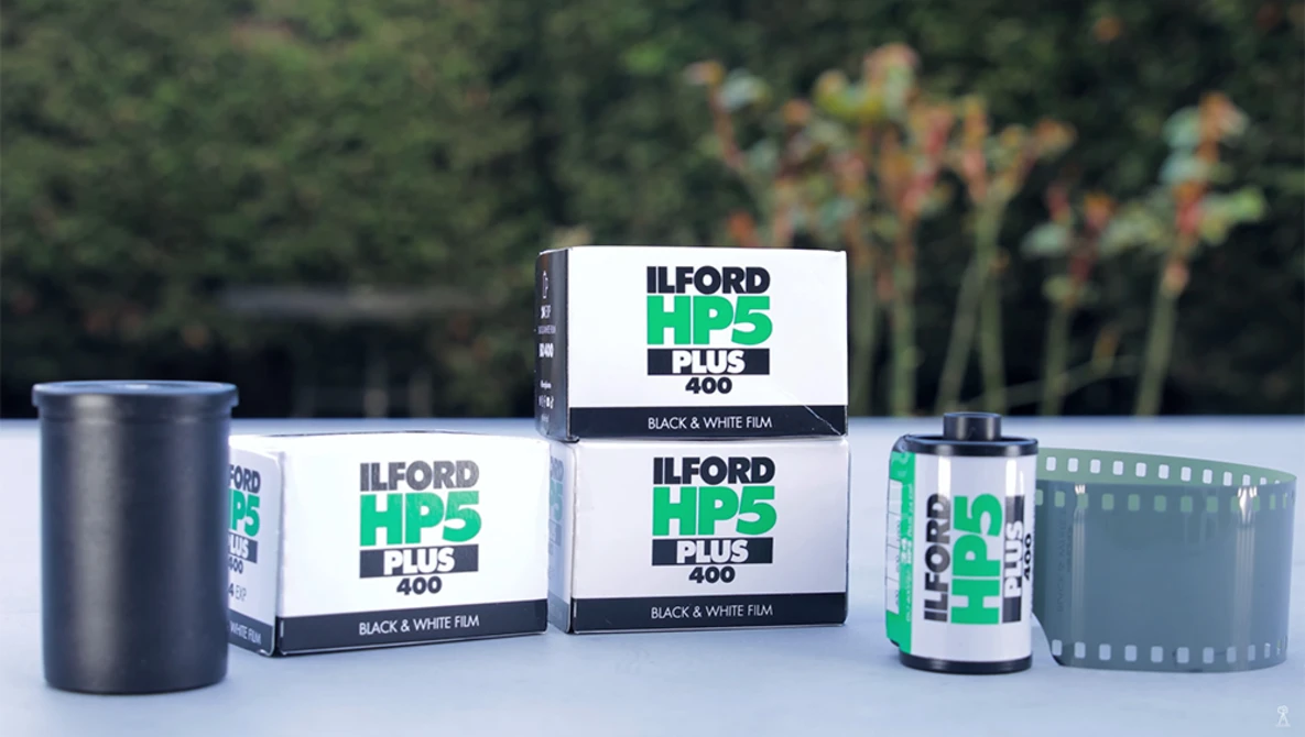 Ilford HP5 Plus 400 black and white film products displayed with canisters and boxes.