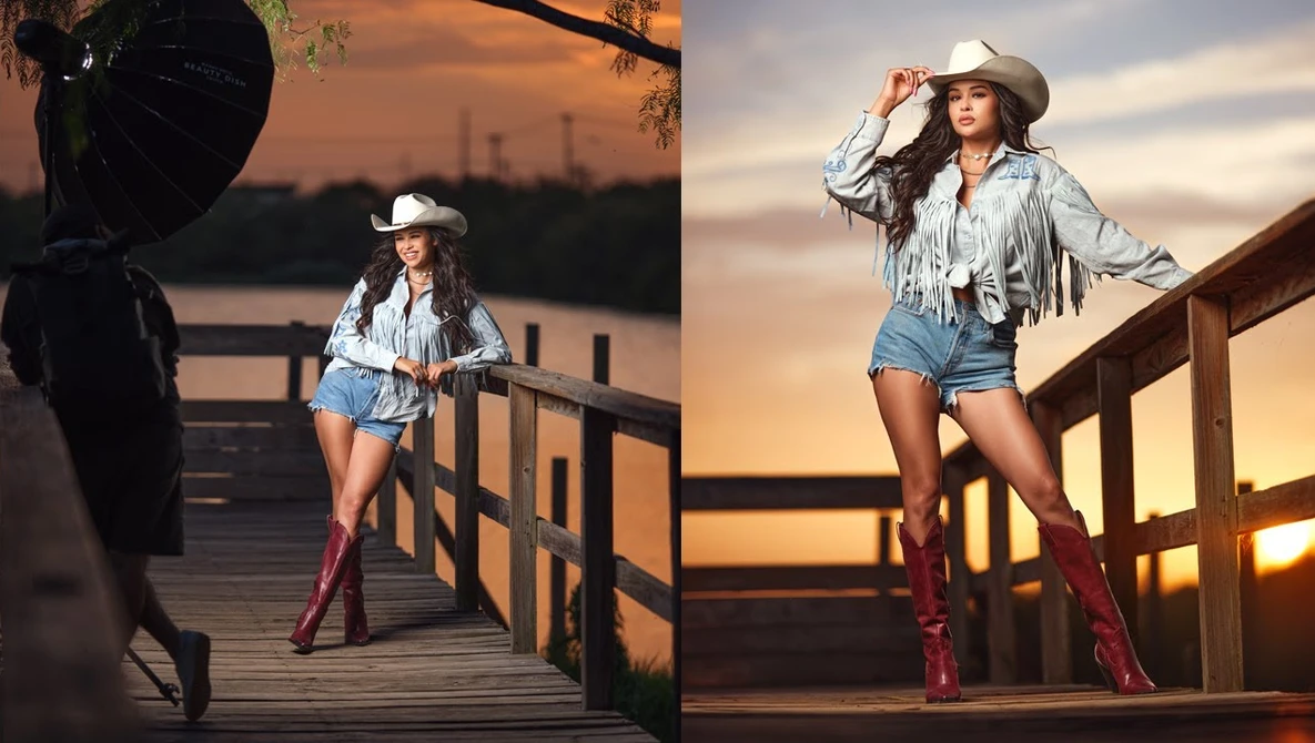 Woman in cowboy hat and denim shorts posing on wooden deck at golden hour sunset.