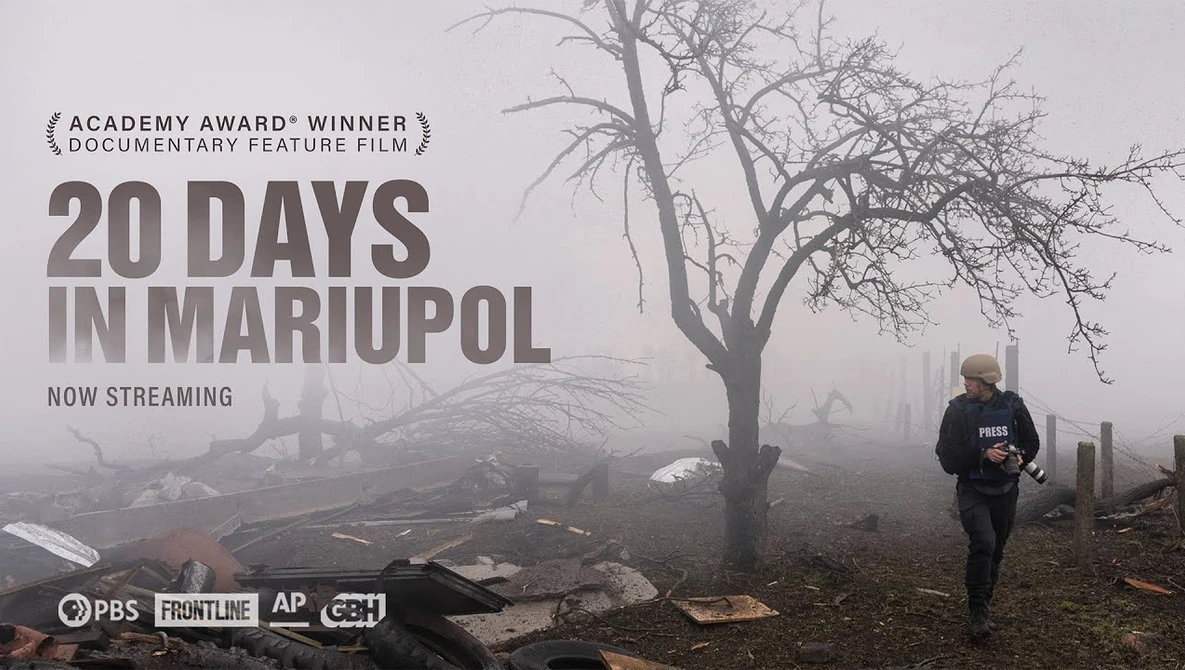 Desolate urban landscape with bare tree and solitary figure in heavy fog and destruction.