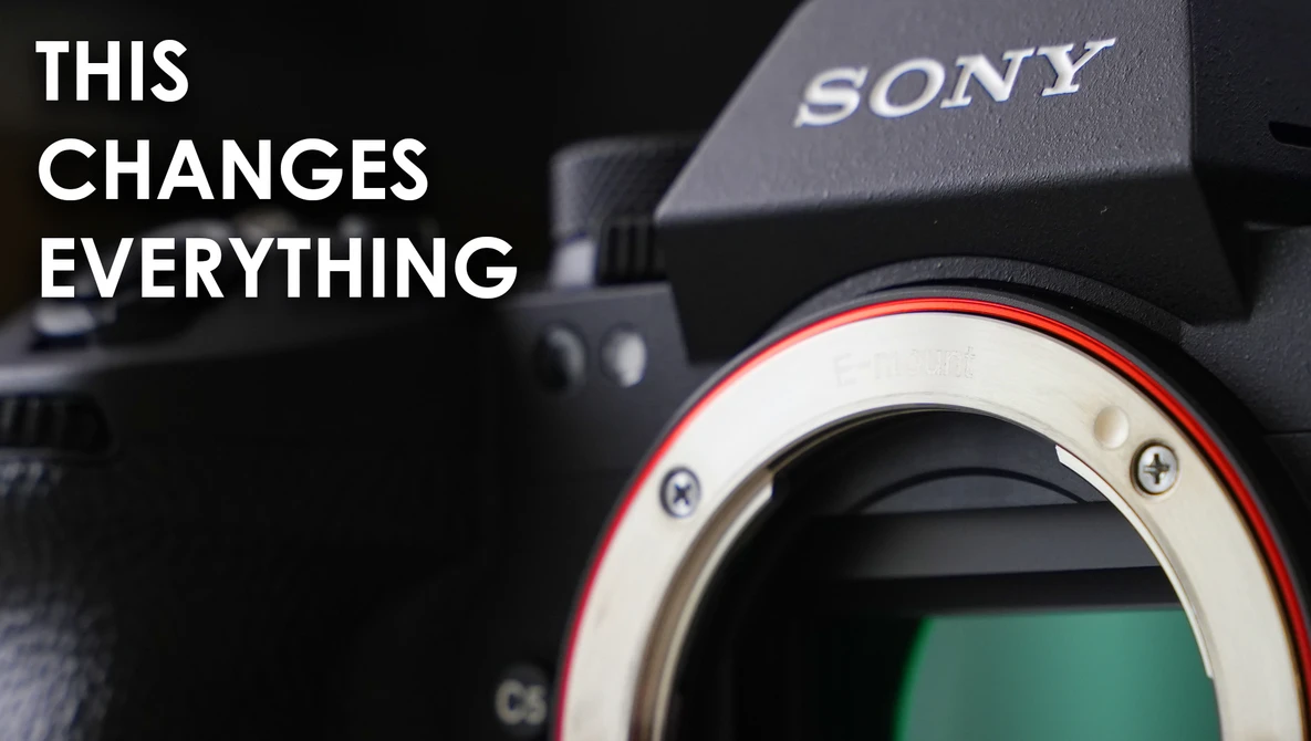 Close-up of Sony camera body showing sensor and lens mount with red accent ring.