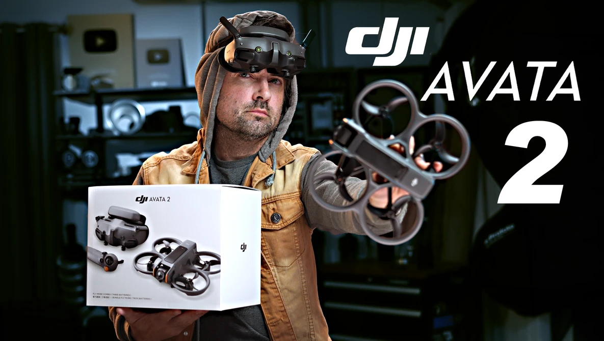 Person wearing FPV goggles and tan jacket holds DJI Avata 2 drone packaging while displaying the assembled quadcopter.