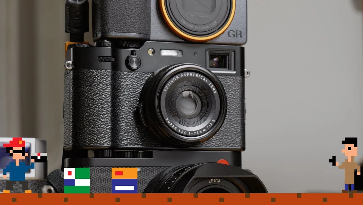 Stack of vintage cameras including a Ricoh GR film camera and Leica lens with pixel art figures and colored film boxes in foreground.