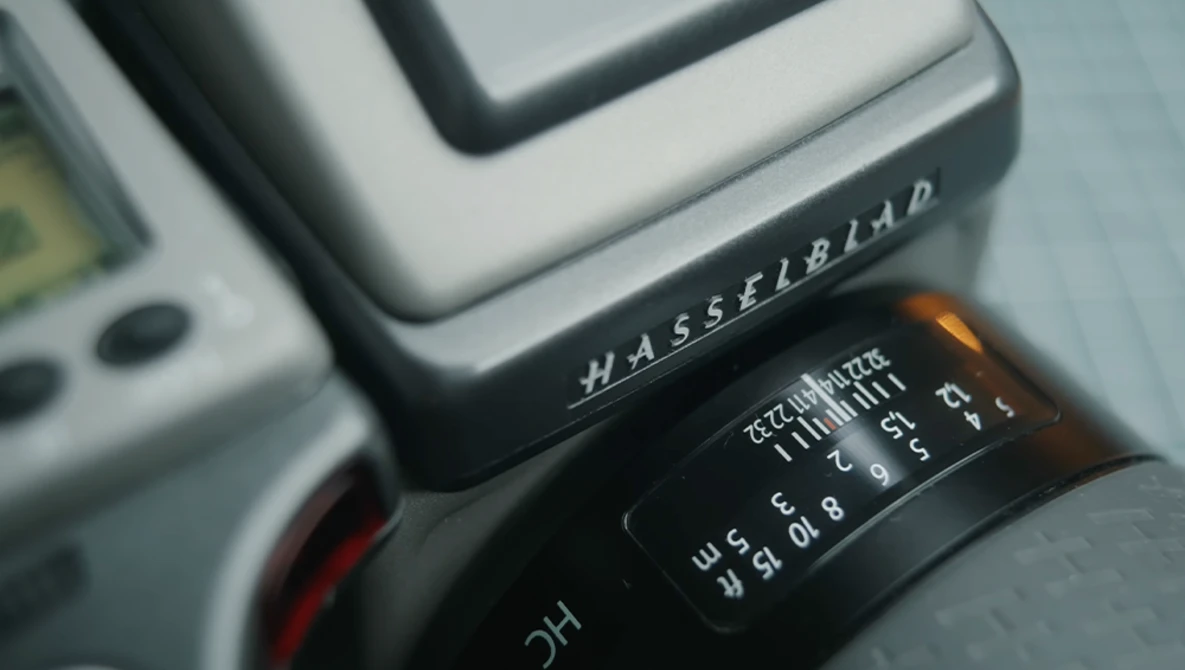 Close-up of Hasselblad camera body showing lens aperture ring and shutter speed dial.