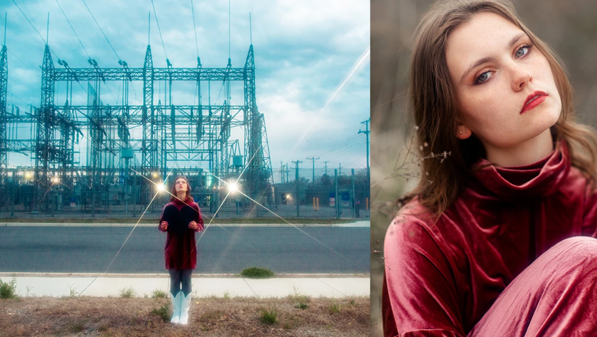 Young woman in burgundy velvet standing before an industrial steel structure with dramatic lighting effects.