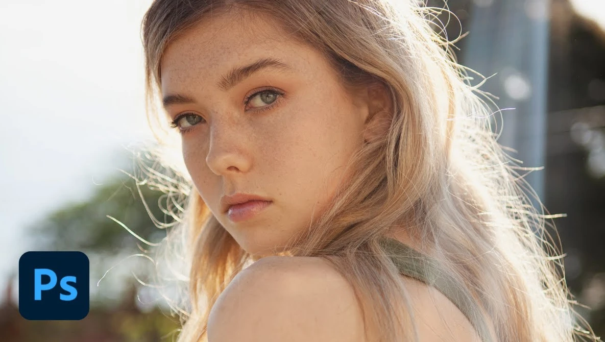 Portrait of a young woman with blonde hair in golden hour sunlight, looking over her shoulder.