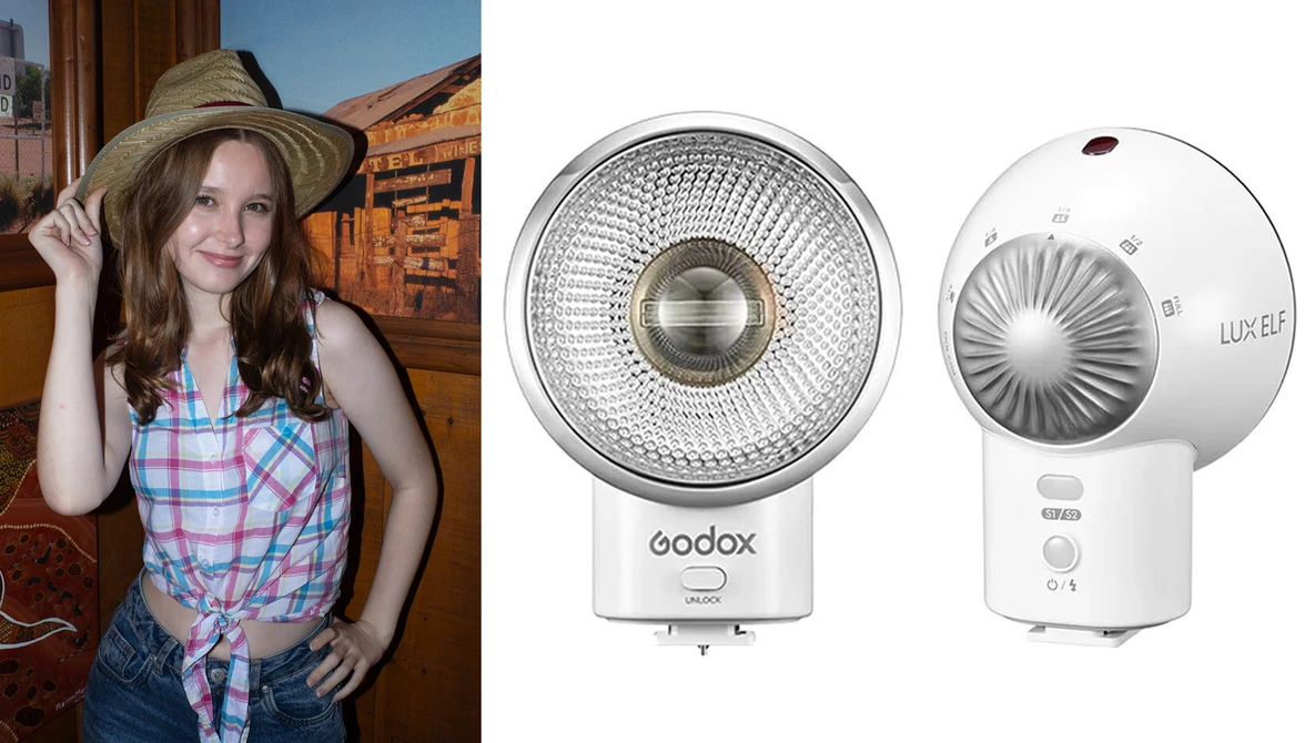 Woman wearing plaid shirt and straw hat posing indoors next to two white LED light fixtures.