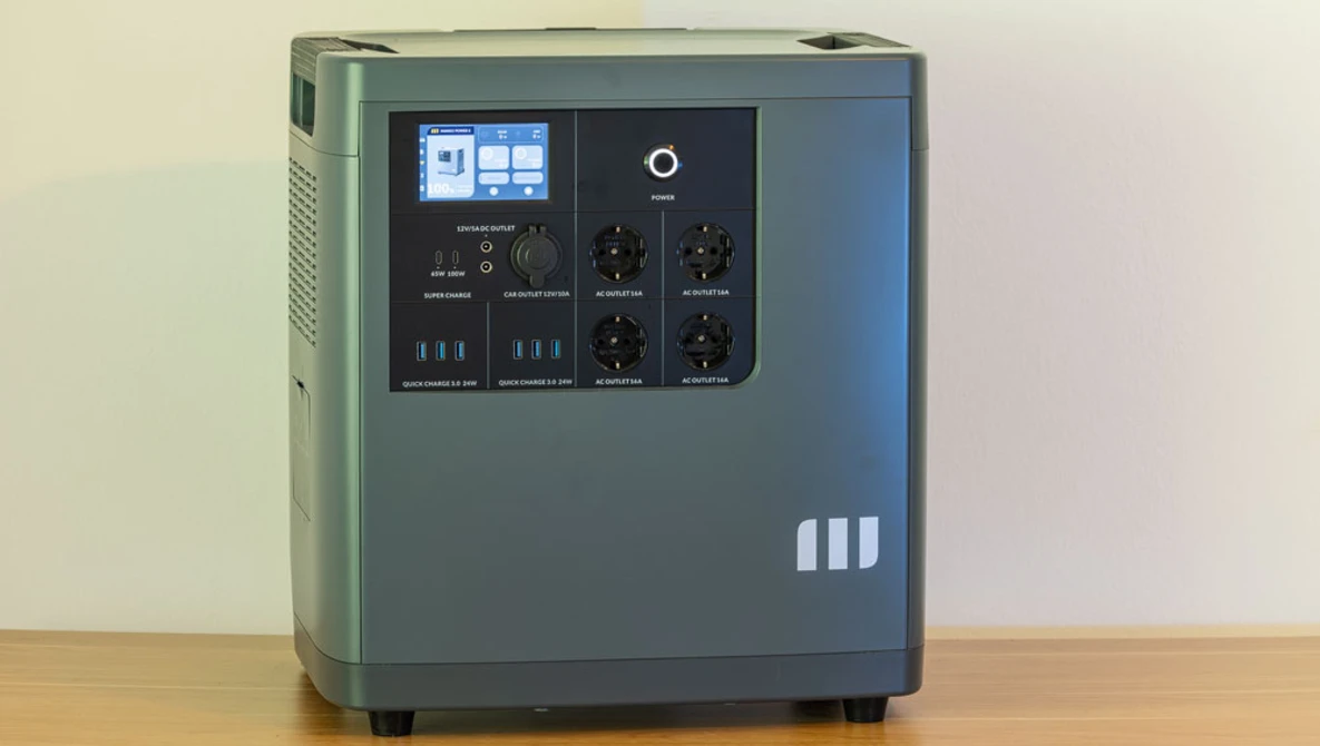 Portable power station with digital display and control panel on wooden surface.