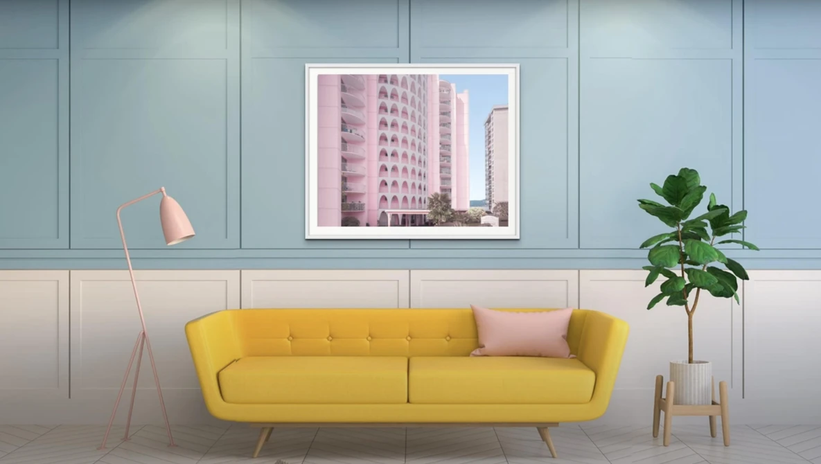 Modern interior design render featuring a yellow sofa against paneled walls with framed architectural photography.