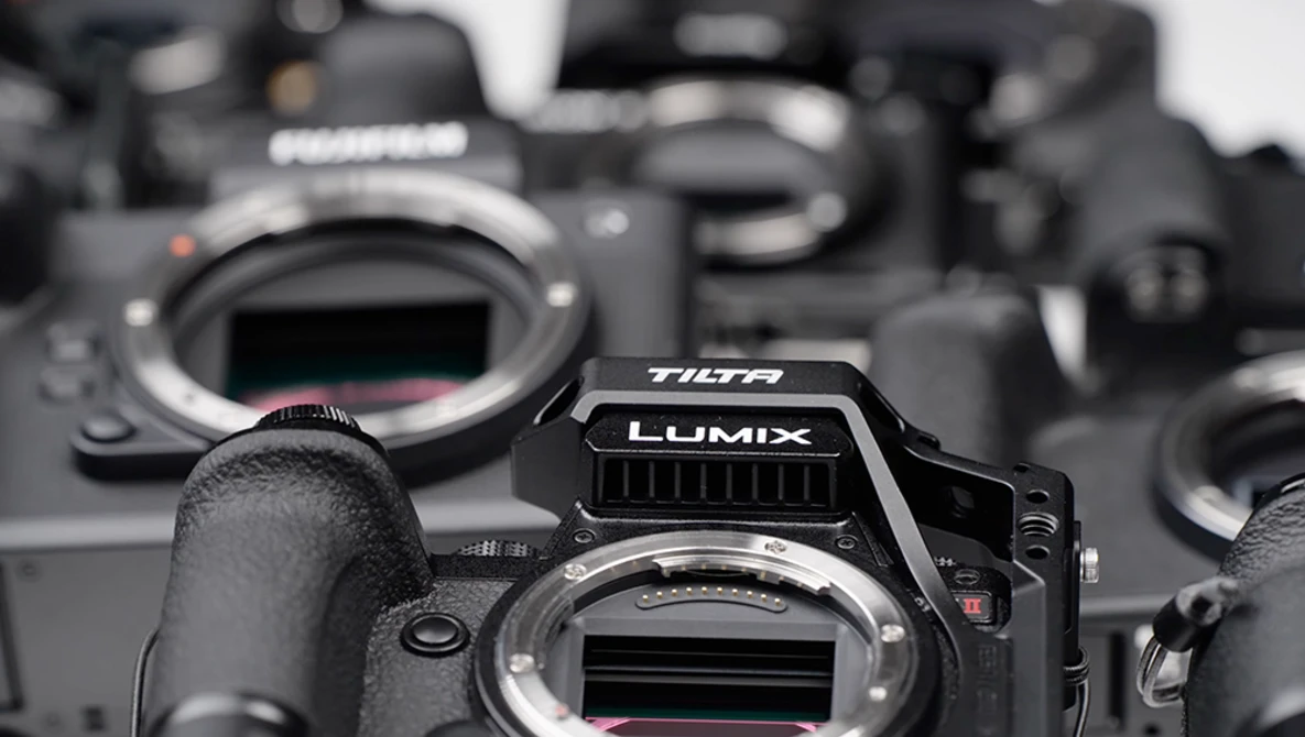 Panasonic Lumix camera body in sharp focus among several other camera bodies in soft focus background.