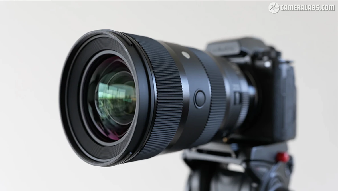 Wide-angle prime lens mounted on a mirrorless camera body against a neutral background.