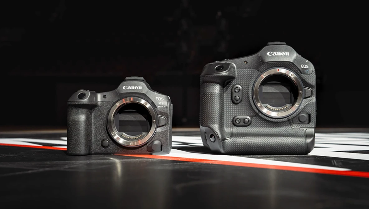 Canon R5 and R6 mirrorless cameras displayed body-to-body against black background with red and white line accent.