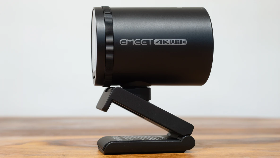EMEET 4K UHD webcam mounted on a black stand against a wooden surface.
