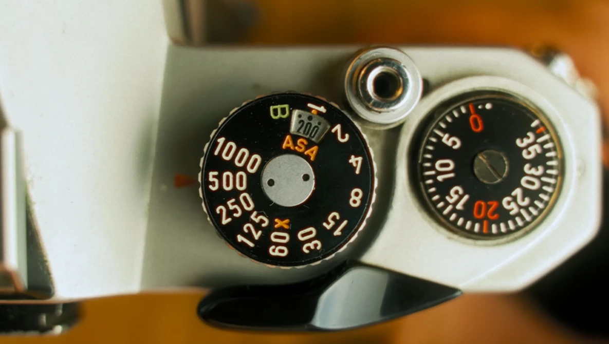 Vintage camera exposure meter dials with ASA settings and aperture values displayed.