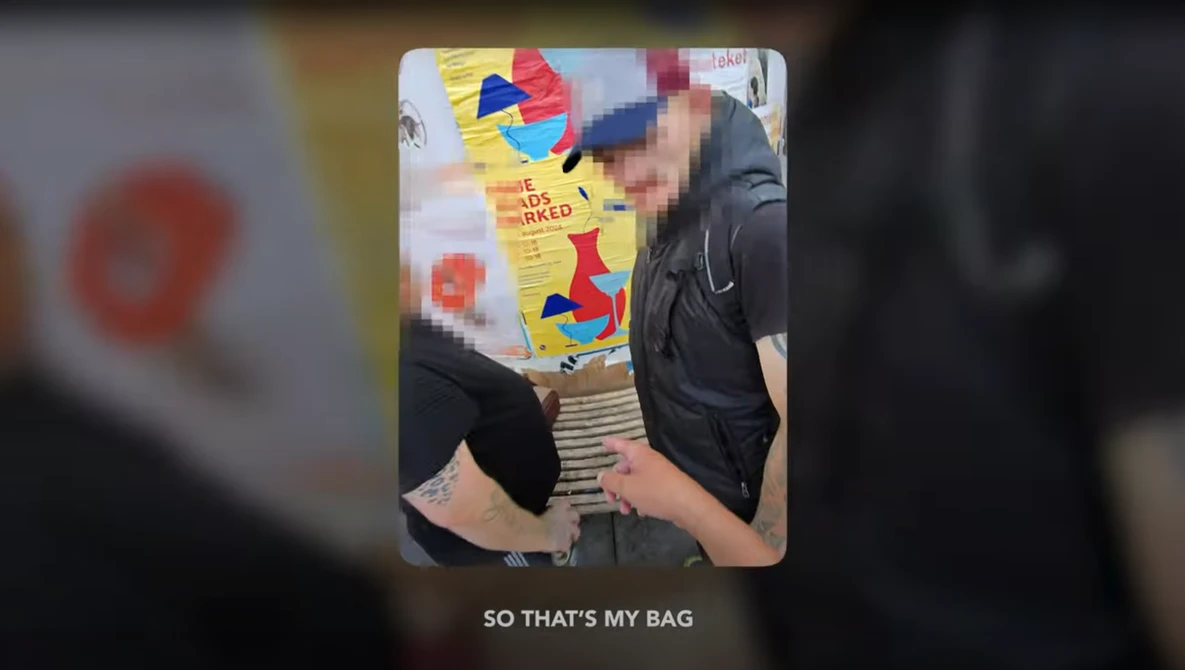 Person holding a colorful toy bag with pixelated graphics and text against a blurred background.
