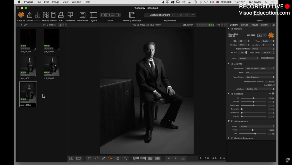 Screenshot of photo editing software displaying a black and white portrait of a man in business attire seated against a dark background.