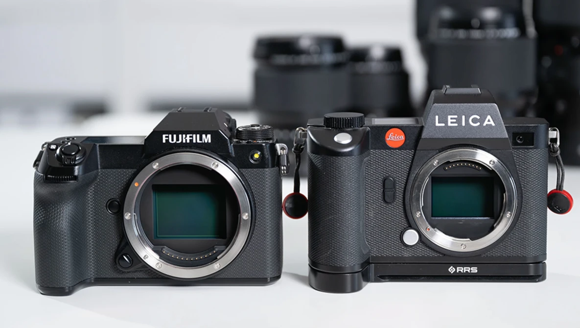 Fujifilm and Leica mirrorless cameras displayed side-by-side, showing sensor openings and control layouts.