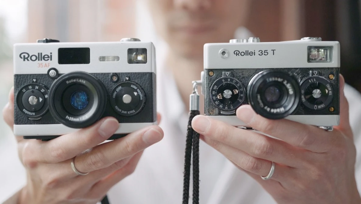 Two Rollei 35mm film cameras held in hands side by side for comparison.