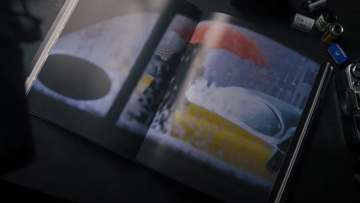 Open portfolio or magazine spread displaying product photography with colored objects and soft, diffused lighting.
