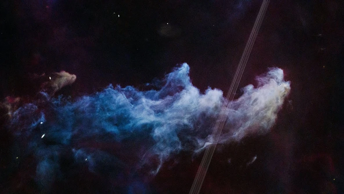 Abstract powder explosion with blue and purple clouds against a dark background.