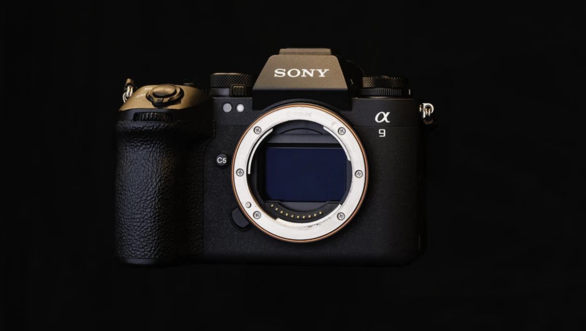 Sony α9 mirrorless camera body front view with lens mount visible against black background.