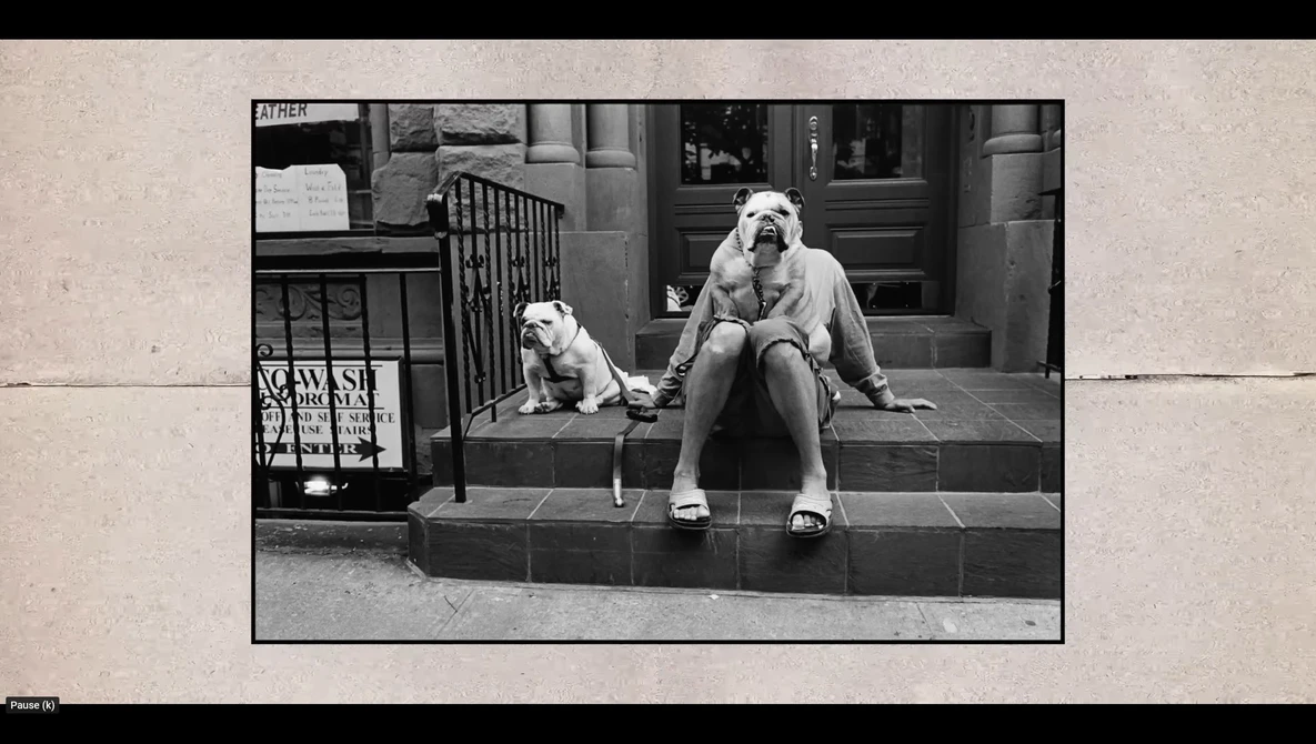 Woman and small dog sitting together on urban building steps in black and white photography.