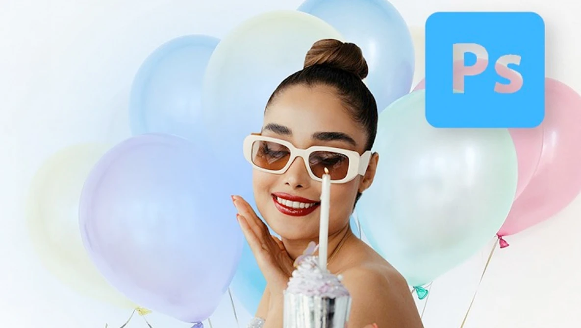 Woman wearing white-framed sunglasses and red lipstick touches her face near colorful balloons.