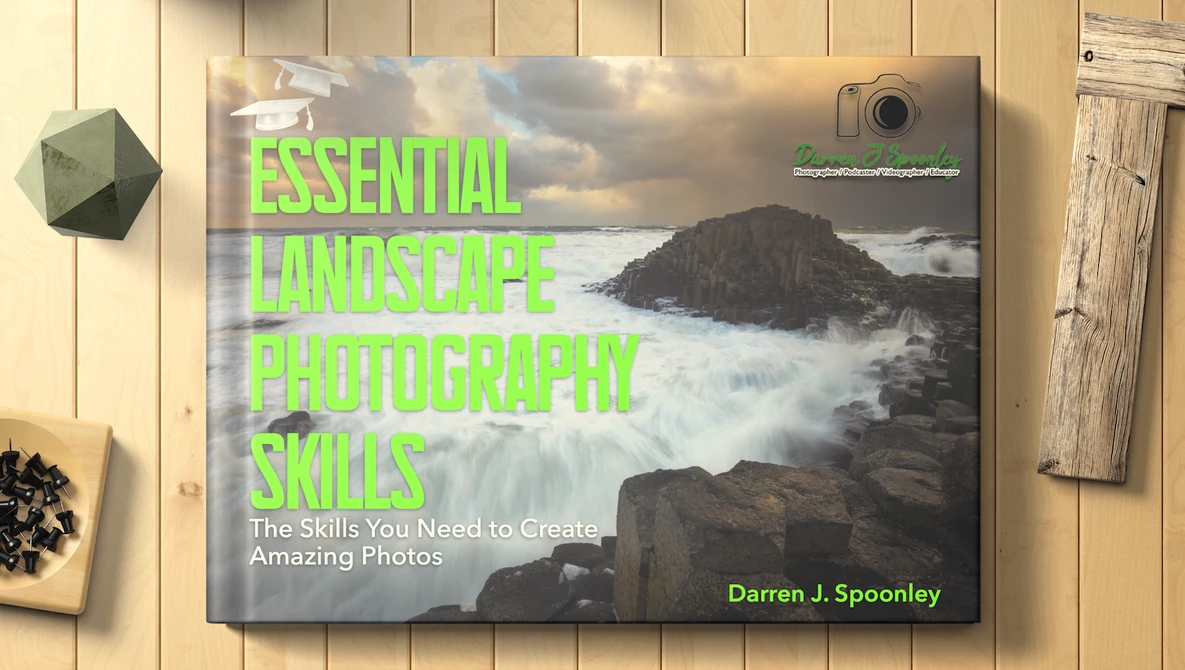Book cover for 'Essential Landscape Photography Skills' by Darren J. Spoonley featuring a dramatic coastal landscape.