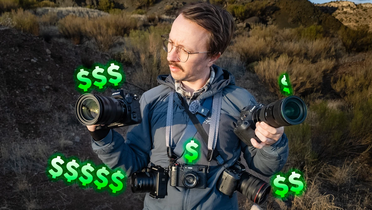 Photographer in desert landscape holding multiple camera lenses with green dollar signs overlaid.