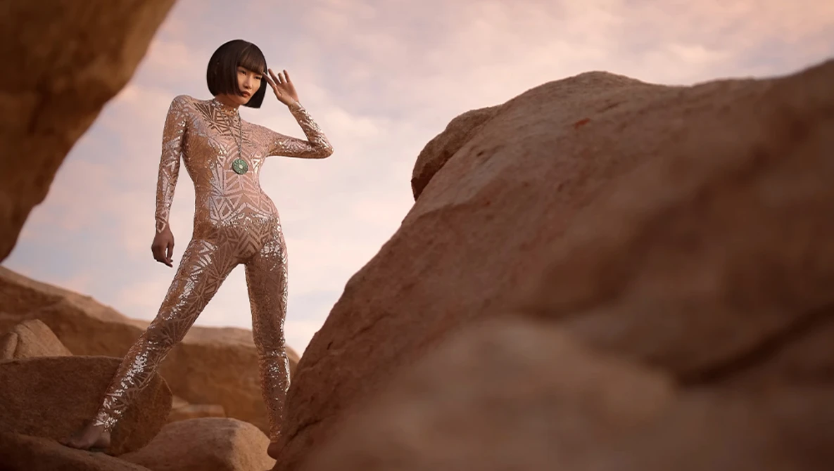 Woman in beaded bodysuit posing on desert rock formations under dramatic sky.