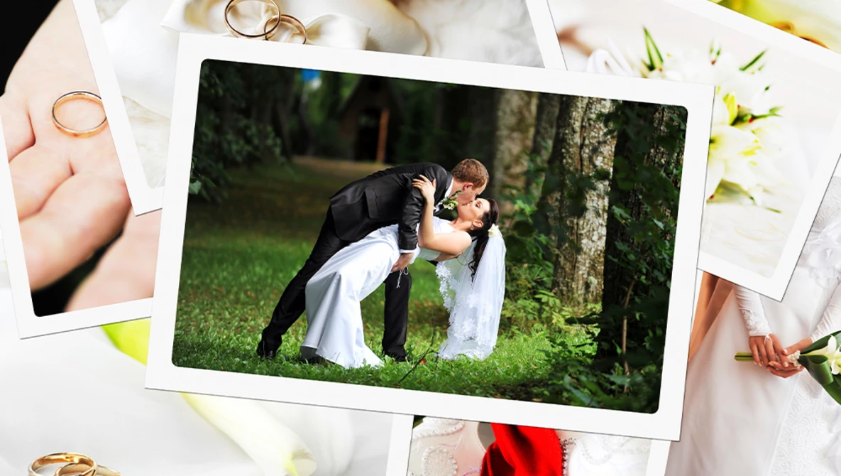 Groom dipping bride during kiss on grass, surrounded by wedding photos and rings.