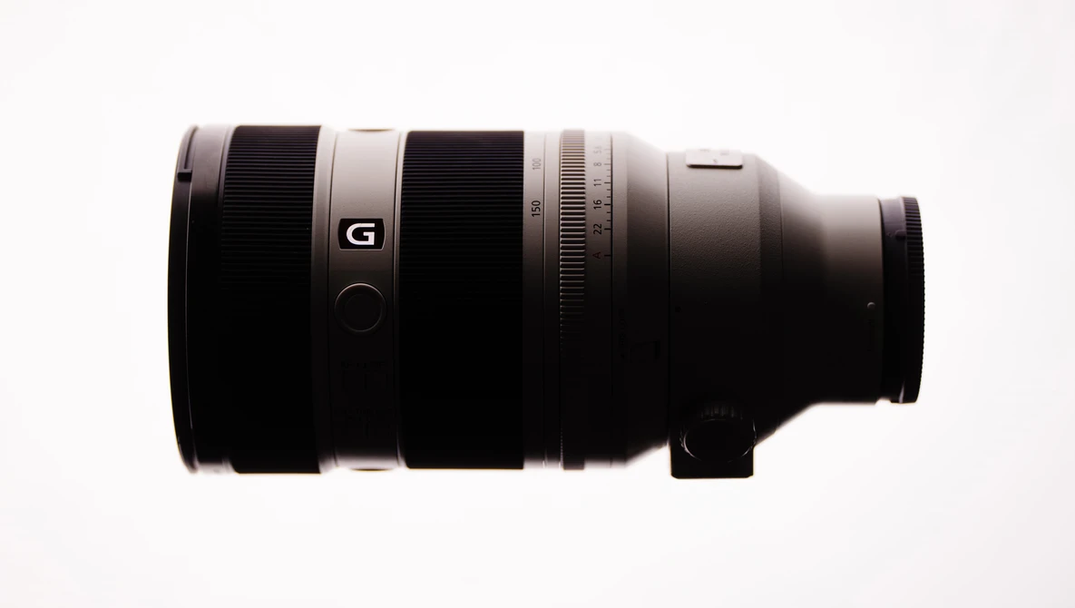 Sony G-series telephoto lens with black barrel and white accent ring on neutral background.