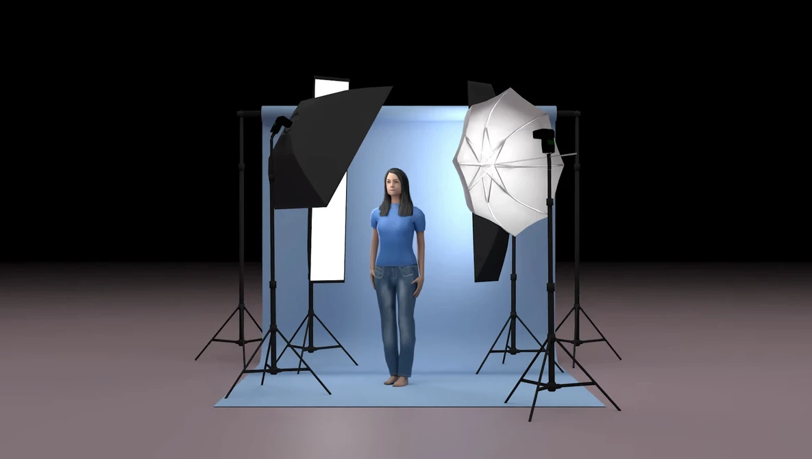 Professional portrait studio setup with model standing on blue backdrop surrounded by softbox and reflector lighting equipment.