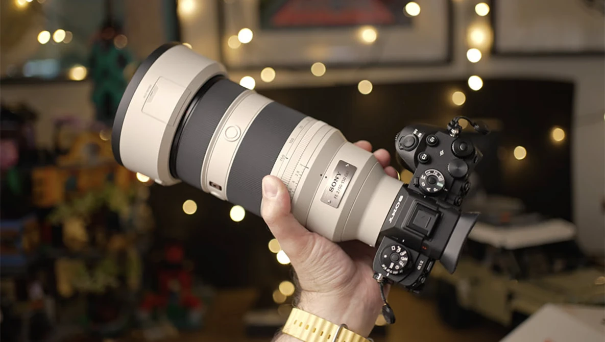 Mirrorless camera with large telephoto lens held up to display the setup during holiday season.