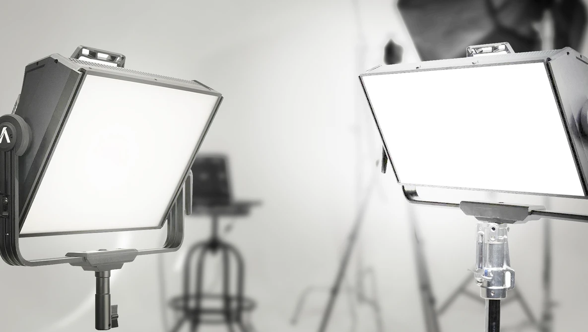 Two panel LED studio lights mounted on stands in a professional photography setup.