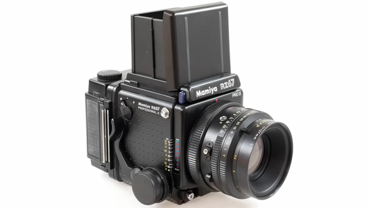 Mamiya RB67 medium format film camera with prism viewfinder and standard lens mounted.