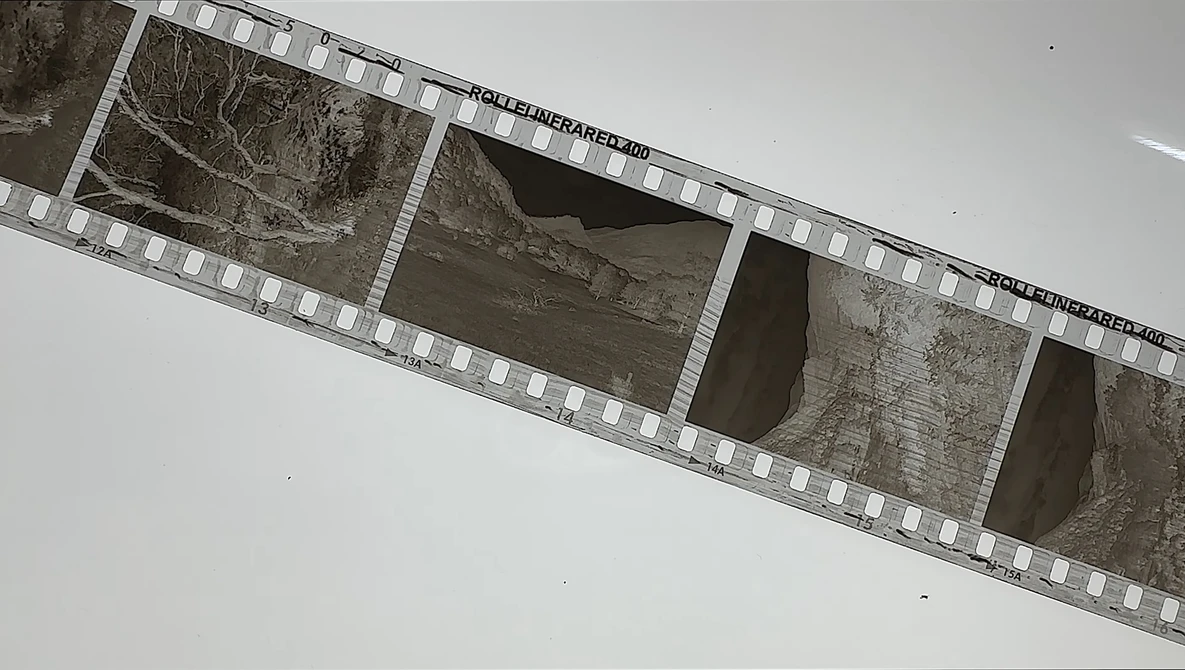 Film strip showing architectural details and concrete structures in black and white.