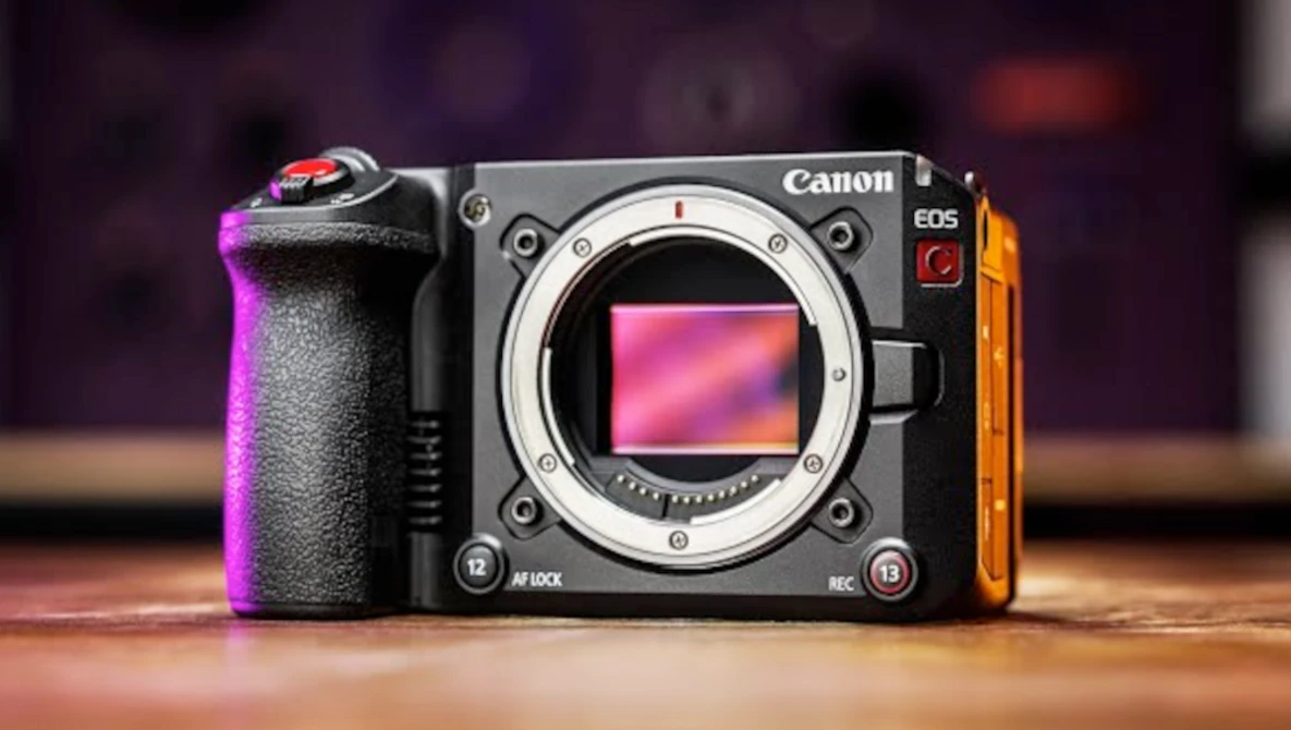 Canon EOS R5 mirrorless camera body displayed against colorful purple and orange gradient lighting.