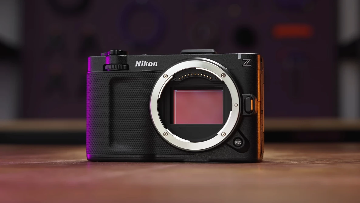 Nikon Z mirrorless camera body with exposed sensor displayed against blurred studio background.